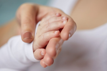 close up of mother and newborn baby hands
