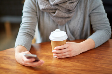 close up of woman with smartphone and coffee