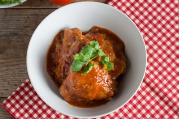 Chicken with sauce tomato in white bowl.