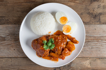 Chicken stew with sauce tomato and egg, rice. Top view.