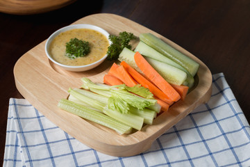 Vegetable sticks. Fresh celery and carrot, cucumber with sauce..