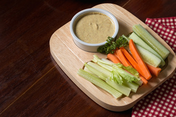 Vegetable sticks. Fresh celery and carrot, cucumber with sauce..