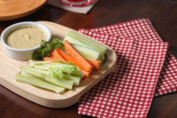 Vegetable sticks. Fresh celery and carrot, cucumber with sauce..