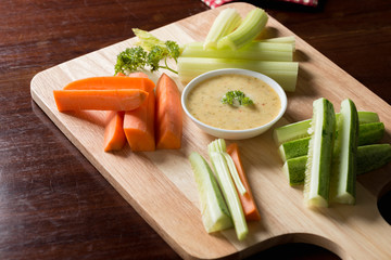 Vegetable sticks. Fresh celery and carrot, cucumber with sauce..