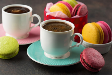 Sweet macarons and cups of coffee