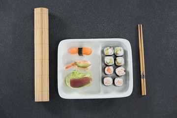 Sushi on tray with chopsticks