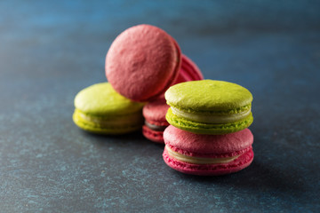Colorful macaroons. Sweet macarons on blue background with copy space. Selective focus
