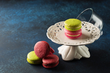 Colorful macaroons. Sweet macarons over blue background with copy space. Selective focus