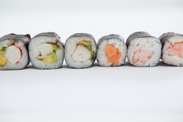 Maki sushi roll arranged on white background