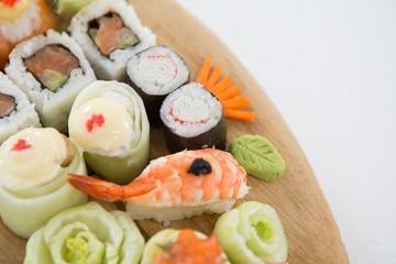 Set of assorted sushi served on wooden tray