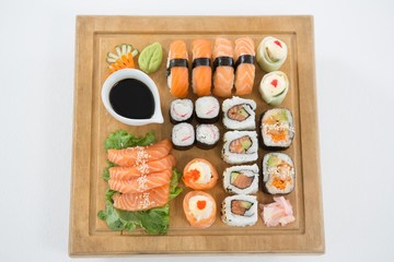 Set of assorted sushi served on wooden tray