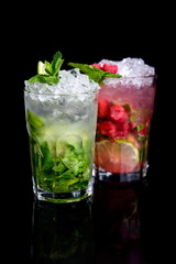 cold drink with mint and raspberries on black background
