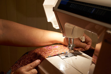 Women's hand sewing the colth