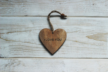 Wooden heart with the word love on a white background