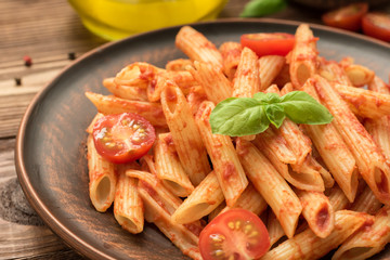 Penne with tomato sauce, fresh basil and tomatoes
