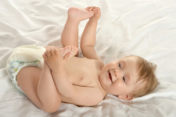 Obraz na płótnie Canvas Baby girl lying in pampers