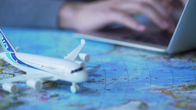 Traveller using laptop to buy flight ticket and book hotel suite online, tourism