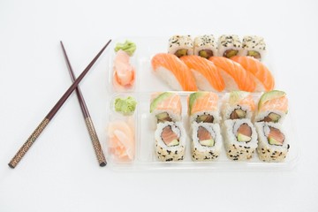Plate of nigiri and uramaki sushi with chopstick