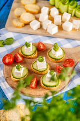 Bread rusks topped with a cube of feta