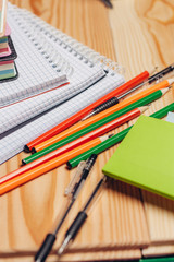 colorful pencils and notebooks on...