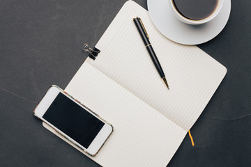 phone lies on a pad, clip, pen