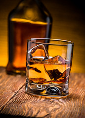 whiskey with ice on a wooden table