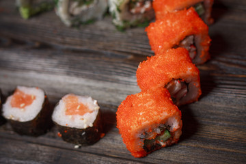 Rolls with caviar and seafood on the table