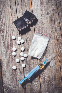 Hard drugs on an old wooden table