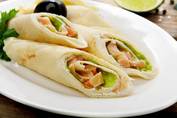 Crepes rolls filled with salted salmon.