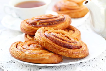 Baked sweet cinnamon rolls with cup of tea