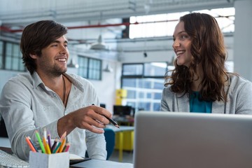 Graphic designers working at desk