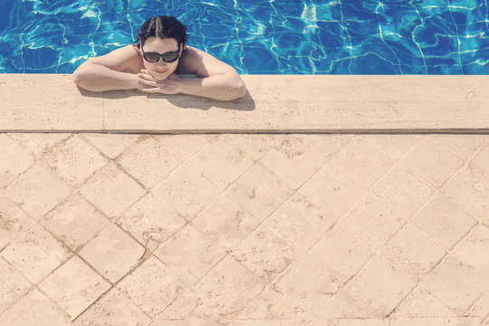 Woman In Sunglasses Near The Pool Edge, Top View