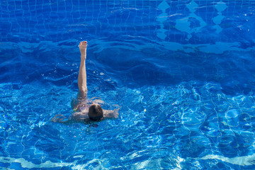 Woman in bikini swims in the pool