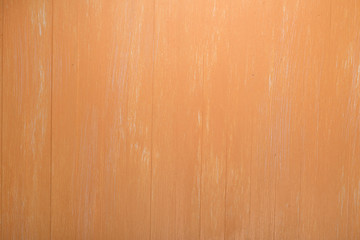 Orange wood background. Painted scraped wooden board. Bright texture or pattern.