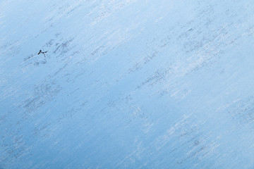 Blue wood background. Painted scraped wooden board. Grunge plywood texture or pattern.