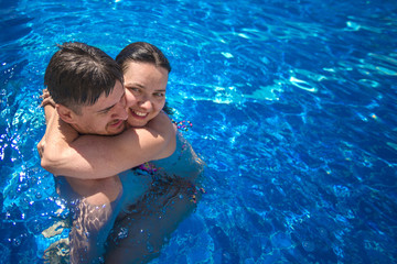 Loving couple in the swimming pool