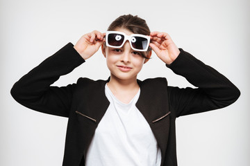 Cheerful young girl wearing sunglasses