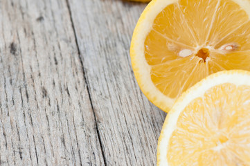 Fresh lemons against a textured rustic wooden work surface