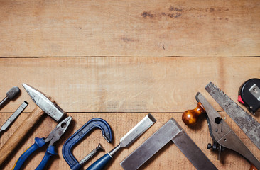 Set of carpenter tools on the wood table. Top view