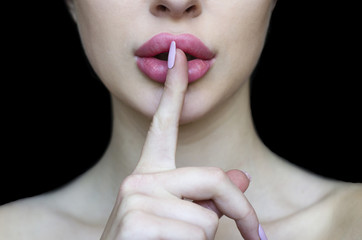 Woman with pink lipstick and finger showing hush silence sign, gesture and beauty concept,  black...