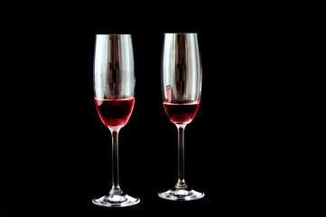 Two glasses with champagne rosè, black background