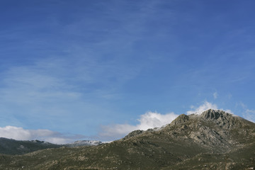 Snowy landscape in winter time. Subject captured after snow storm over blue sky background. 