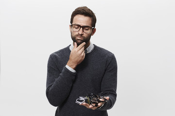 Man choosing spectacles in studio