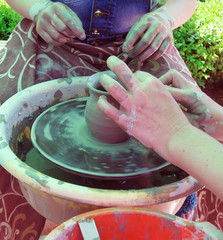 Master class in pottery, hands molded pot on potter's wheel