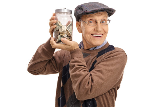 Joyful elderly man holding a jar with money
