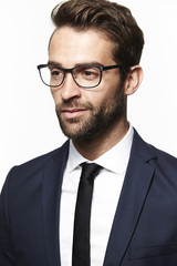Glasses man in sharp suit, looking away