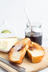 toast, butter and jam in the pot closeup