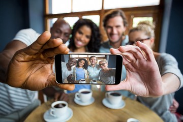 Group of friends taking a selfie from mobile phone - Powered by Adobe