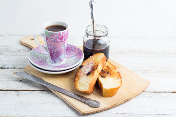 toast with butter, jam and coffee on a white background