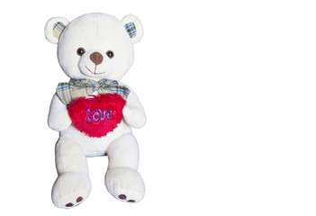 Brown bear doll is holding the red heart over the white background